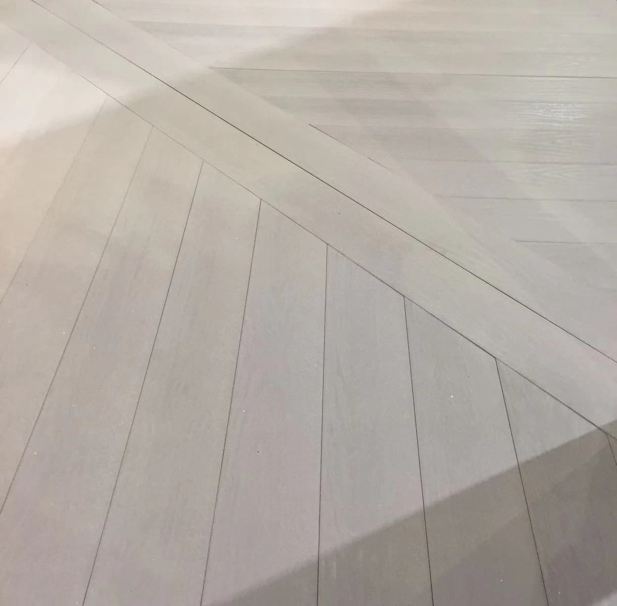 Two each of gray, white, and black shirts laying flat.